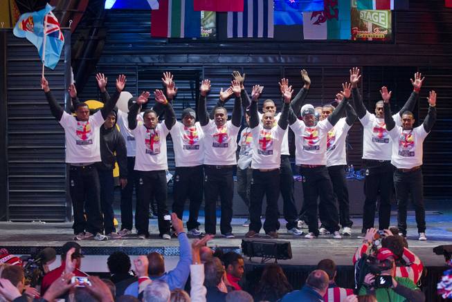 USA Sevens International Rugby Tournament players from Fiji wave to the fans on stage during opening ceremonies at the Fremont Street Experience on Thursday, Jan. 23, 2014.